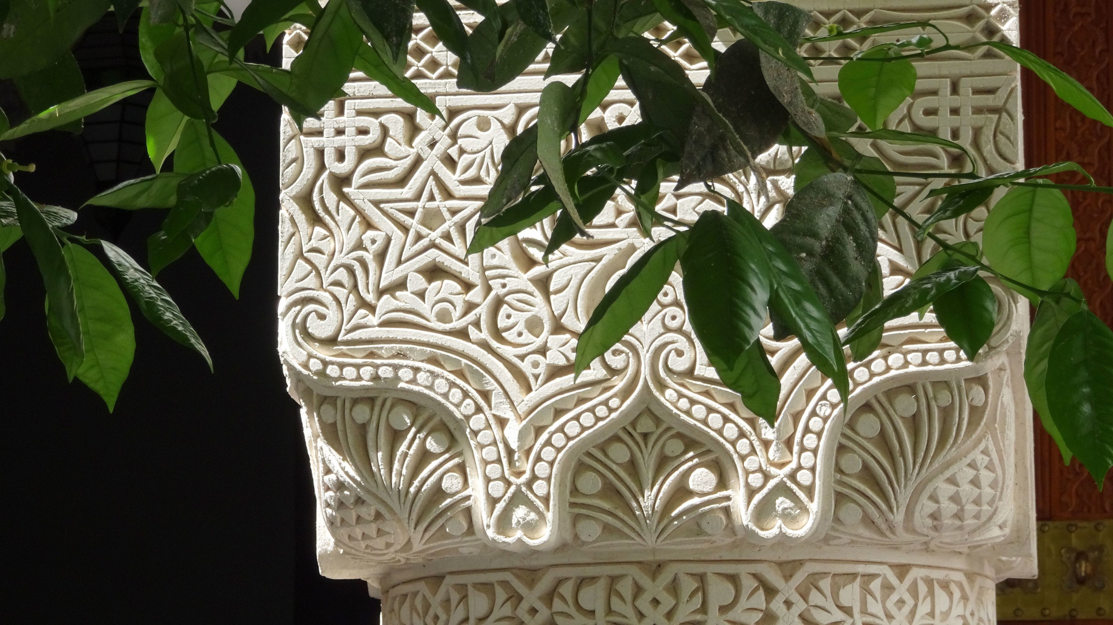 A detailed carved architectural column with intricate patterns.