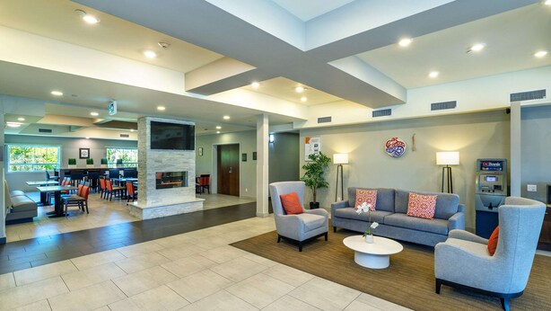 A spacious lobby with a seating area, a fireplace, and a reception desk. - Comfort Inn & Suites (Terrace)