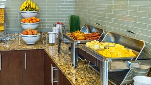 A buffet setup with various food items including fruits, vegetables, and meats. - Comfort Inn & Suites (Terrace)