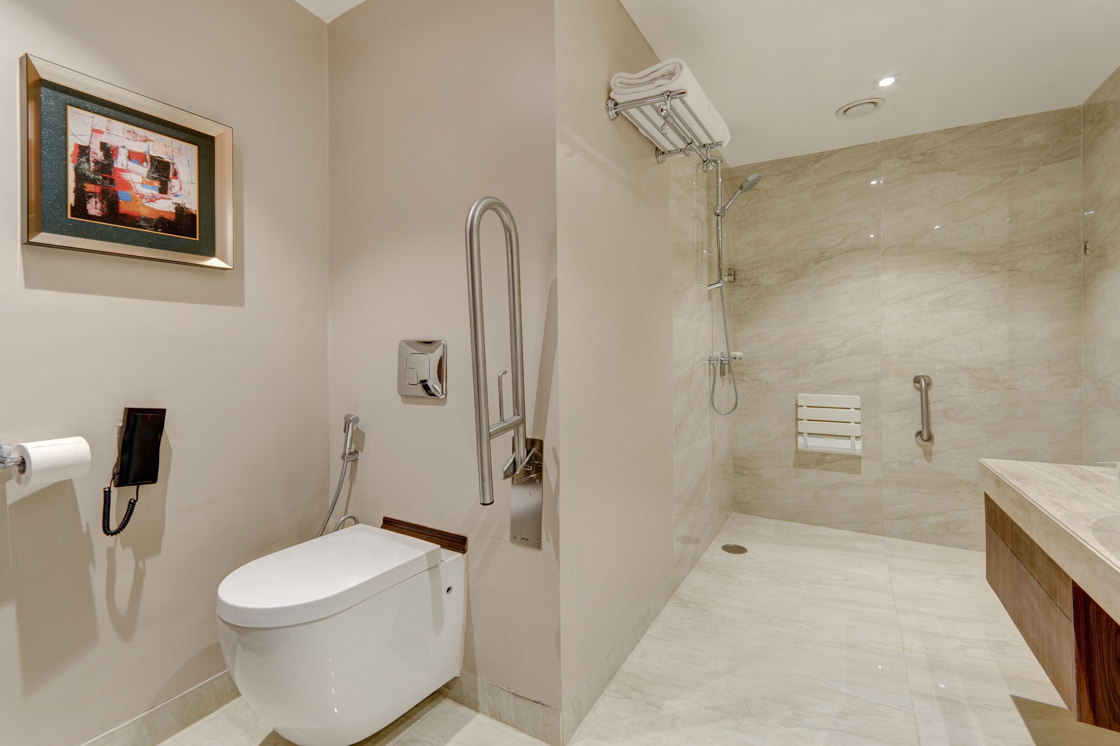 A modern bathroom with a toilet, a shower, and a sink.
