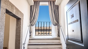 A staircase leading to a balcony with a clear view of buildings.