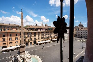Stunning city views from a high vantage point, featuring a historic obelisk and fountain.
