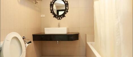 A bathroom with a toilet, sink, and bathtub.