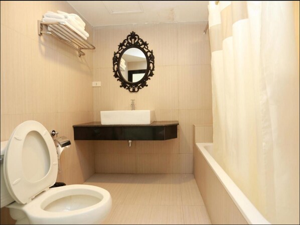 Un baño con inodoro, lavamanos y bañera.