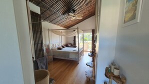 A bedroom with a canopy bed, wooden flooring, and a view of the outdoors. - Villa Bora Bora (Gujan-Mestras)