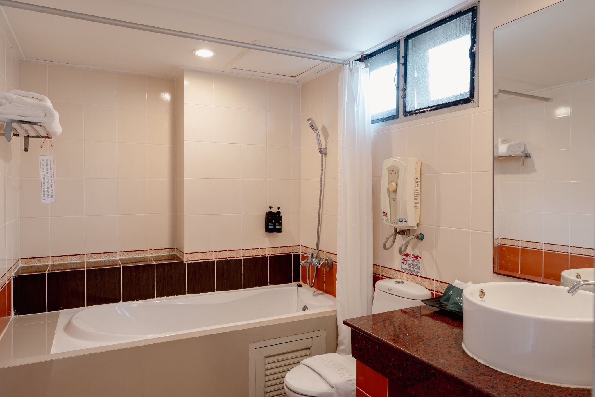 A bathroom with a bathtub, a toilet, a sink, and a shower.