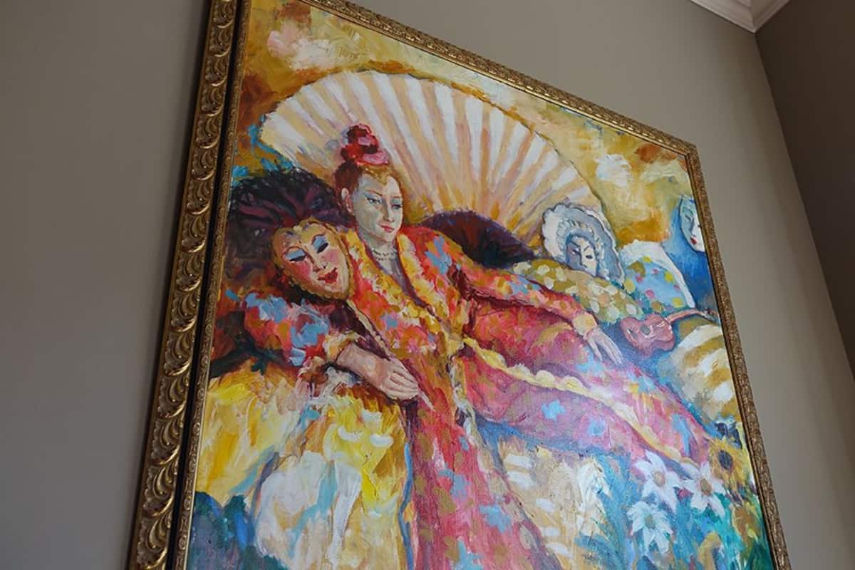 A large, colorful painting on a wall.