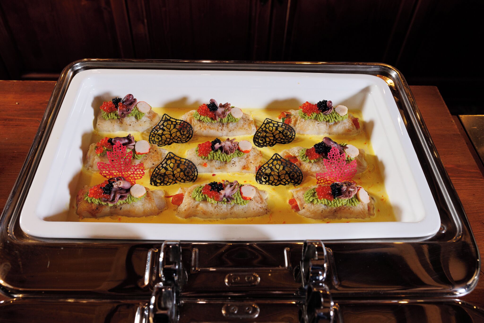 A tray of sushi dishes with various toppings and garnishes.