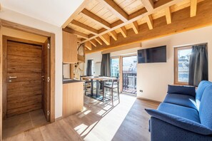 One-Bedroom Apartment in the Attic | Living area | 32-inch TV with cable channels - Residence Nevegall by Original Galli (Livigno)