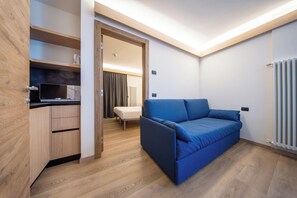 Deluxe Apartment, 1 Bedroom | Living area | 32-inch TV with cable channels