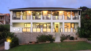 A two-story building with a sign indicating it is a B&B. - Greystone Guest House (Jeffreys Bay)