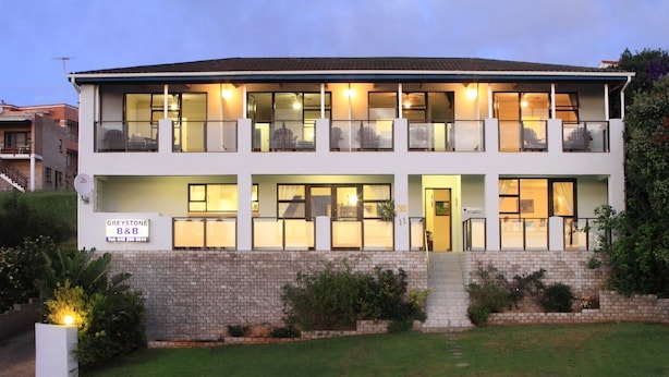 A two-story building with a reception area, multiple windows, and a brick facade. - Greystone Guest House (Jeffreys Bay)