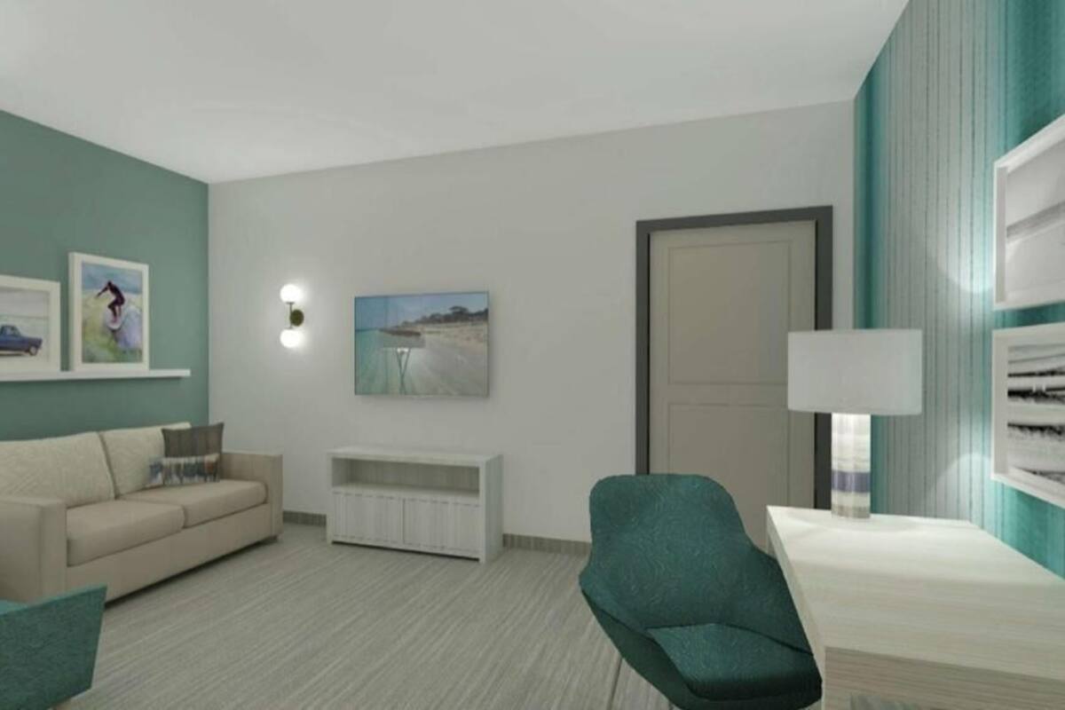 A modern living room with a sofa, armchairs, a coffee table, a TV stand, and wall-mounted artwork.