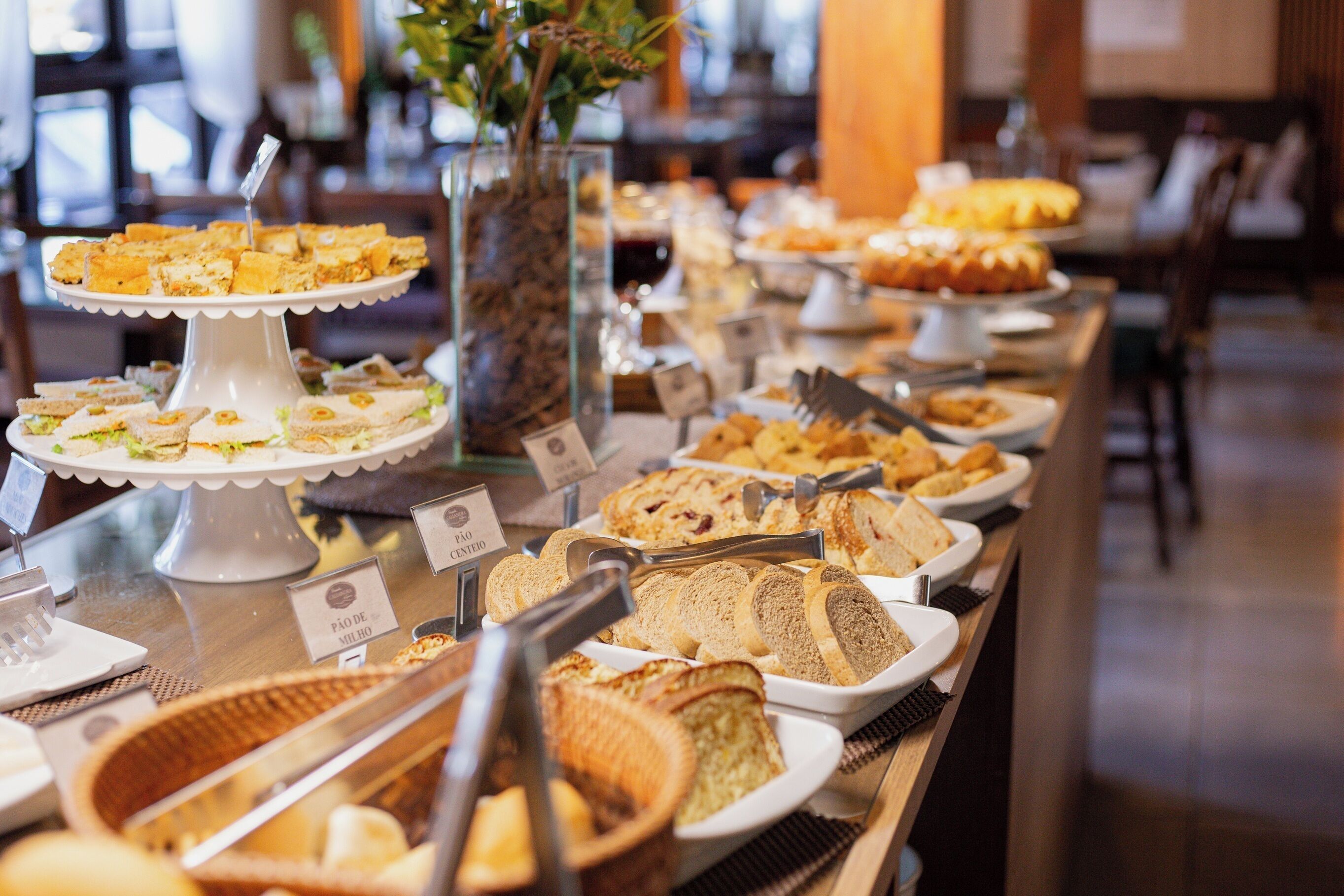 A buffet with various food items and labels.
