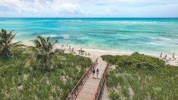 On the beach, white sand, sun loungers, beach umbrellas