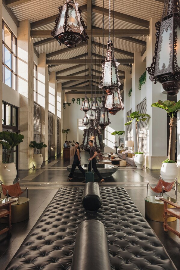A spacious lobby with a large black leather sofa, hanging ornate lanterns, and potted plants. - Unico Hotel Riviera Maya - Adults Only - All Inclusive (Kantenah)