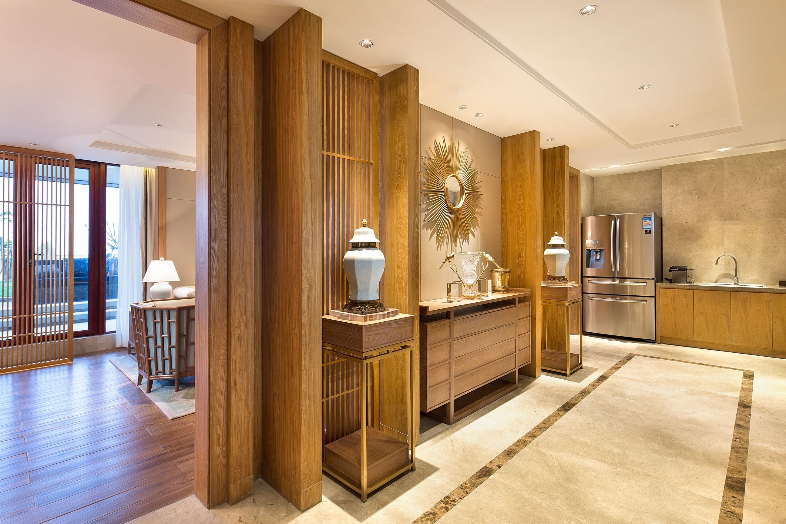 A modern kitchen with wooden cabinetry, a central island, and stainless steel appliances.