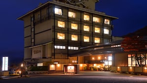 A multi-story hotel with illuminated windows and a well-lit entrance. - Sakaeya Hotel (Tendo)