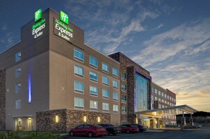 A Holiday Inn Express hotel with a brick facade, multiple windows, and a covered entrance.