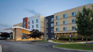 A multi-story hotel with a modern design, featuring a prominent entrance with a covered area and a flagpole. - Fairfield Inn & Suites by Marriott Richmond Ashland (Ashland)