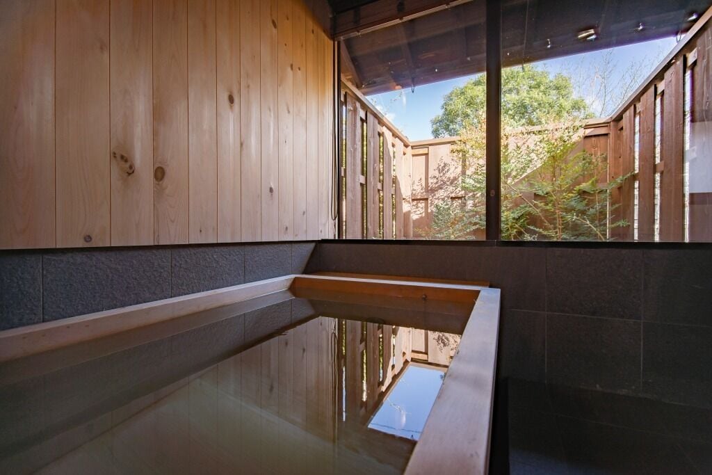 A wooden interior with a glass-enclosed pool area.