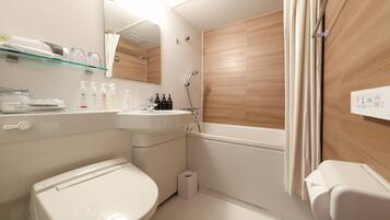 A modern bathroom with a toilet, sink, and shower.