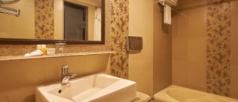 A bathroom with a sink, toilet, and bathtub.