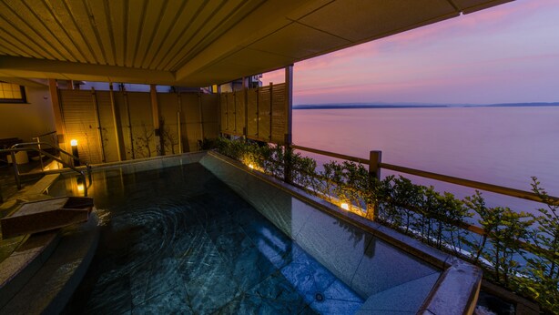 A swimming pool with a view of the water at dusk. - Kagaya (Nanao)