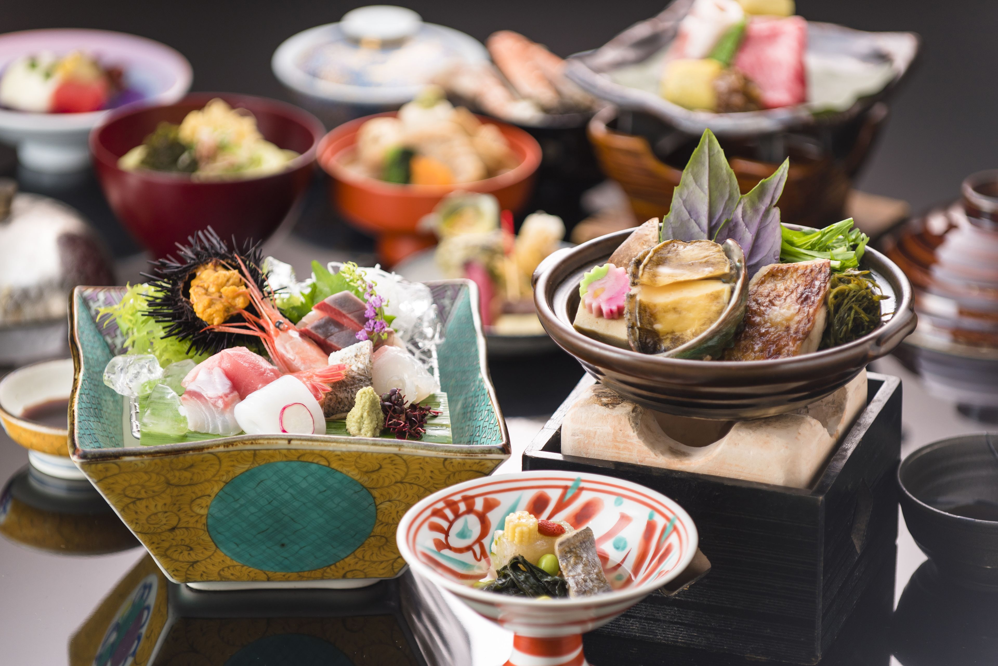 Une variété de plats traditionnels japonais présentés dans différents bols et assiettes.
