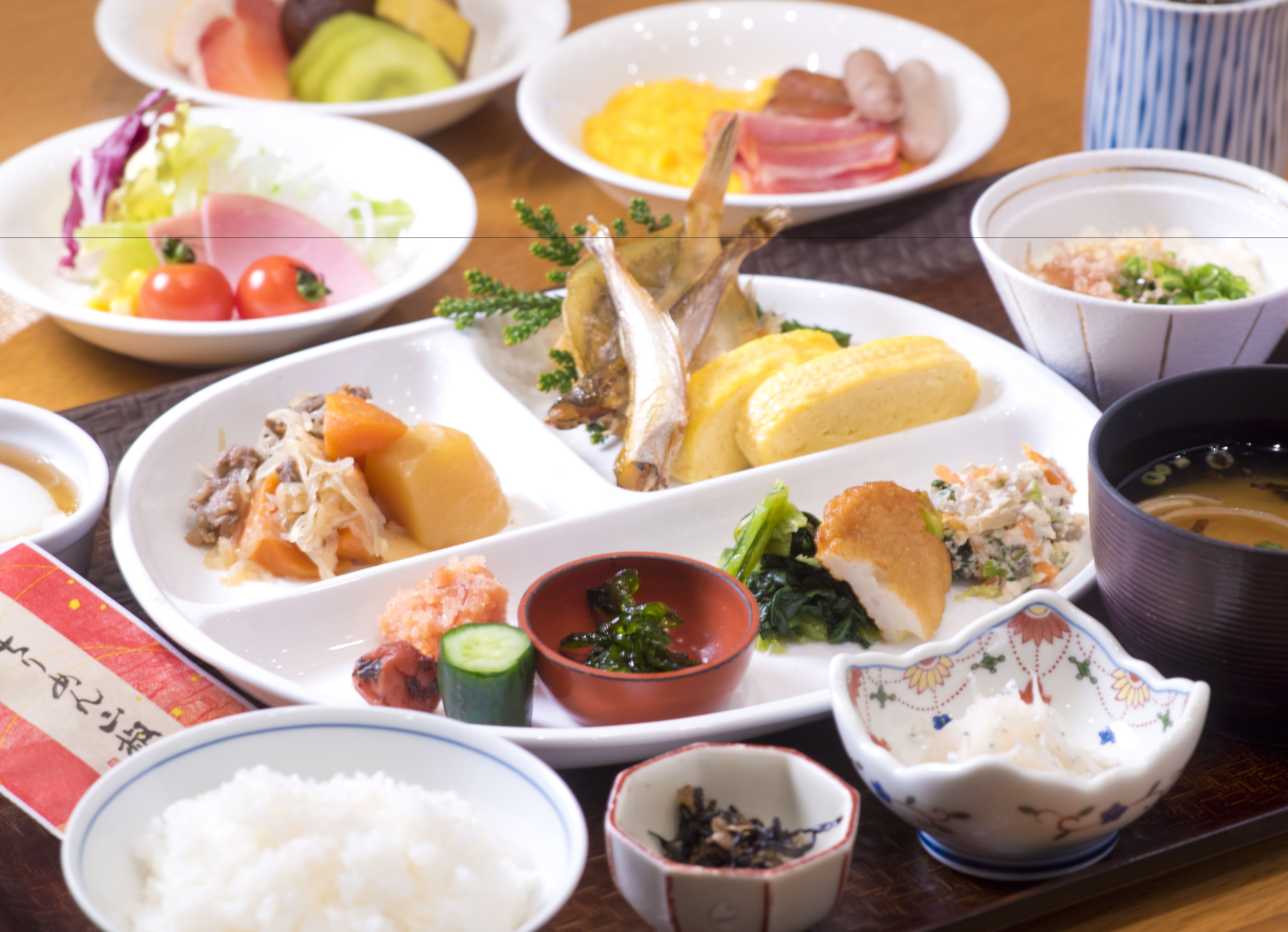 A variety of dishes on a table, including rice, vegetables, and meat.
