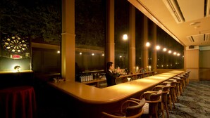 A bar area with a dartboard, bar stools, and a long counter. - Aenokaze (Nanao)