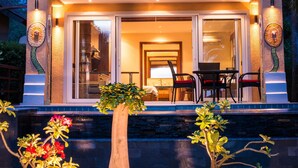 A two-story house with a balcony, large windows, and a well-lit entrance. - Villa Manipura (Ko Chang)