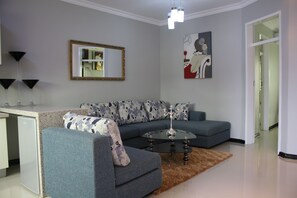 Relax in this stylish living room with a comfortable sofa, coffee table, and floor lamp.