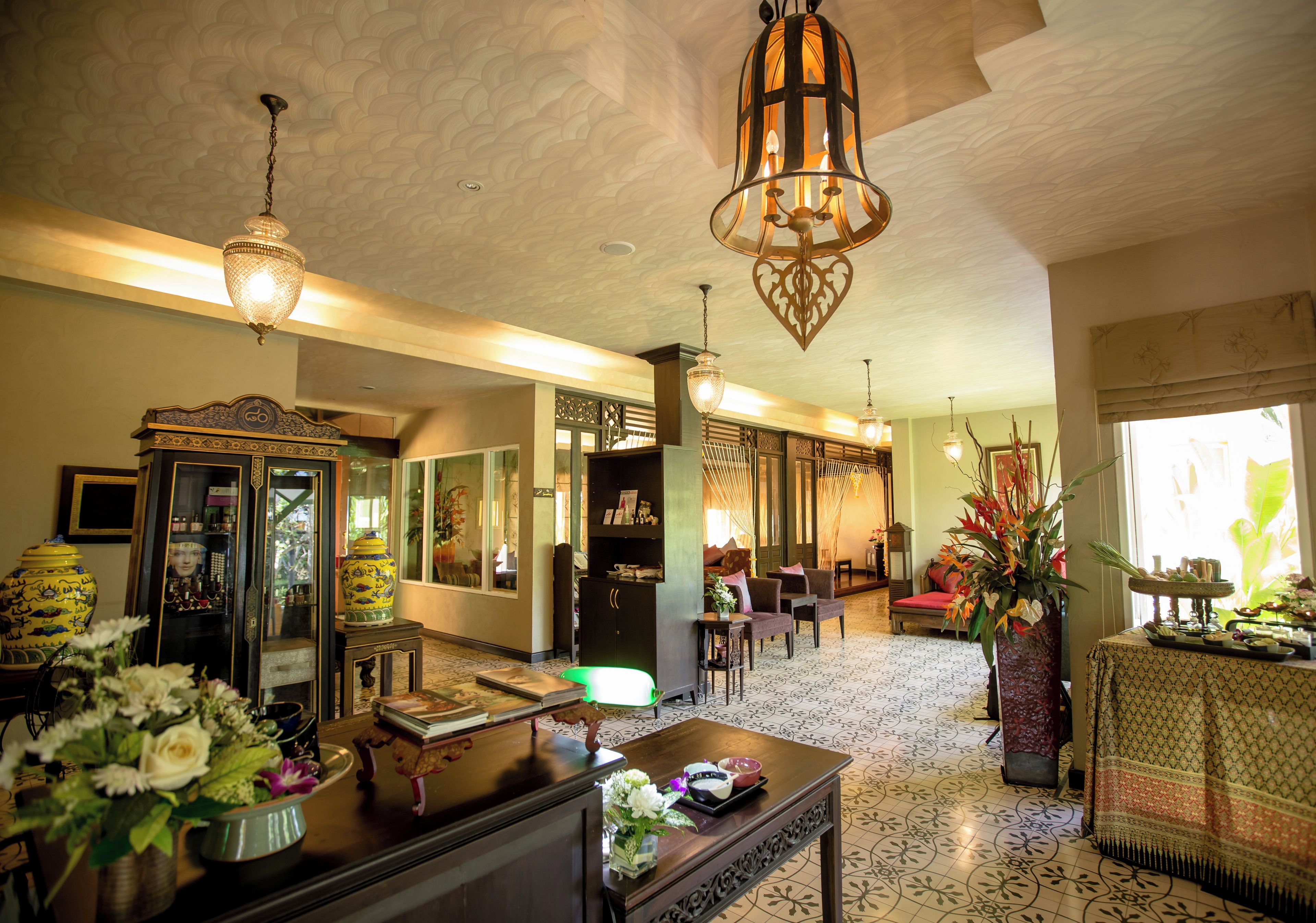 A traditional interior with ornate furniture, a patterned floor, and decorative lighting fixtures.