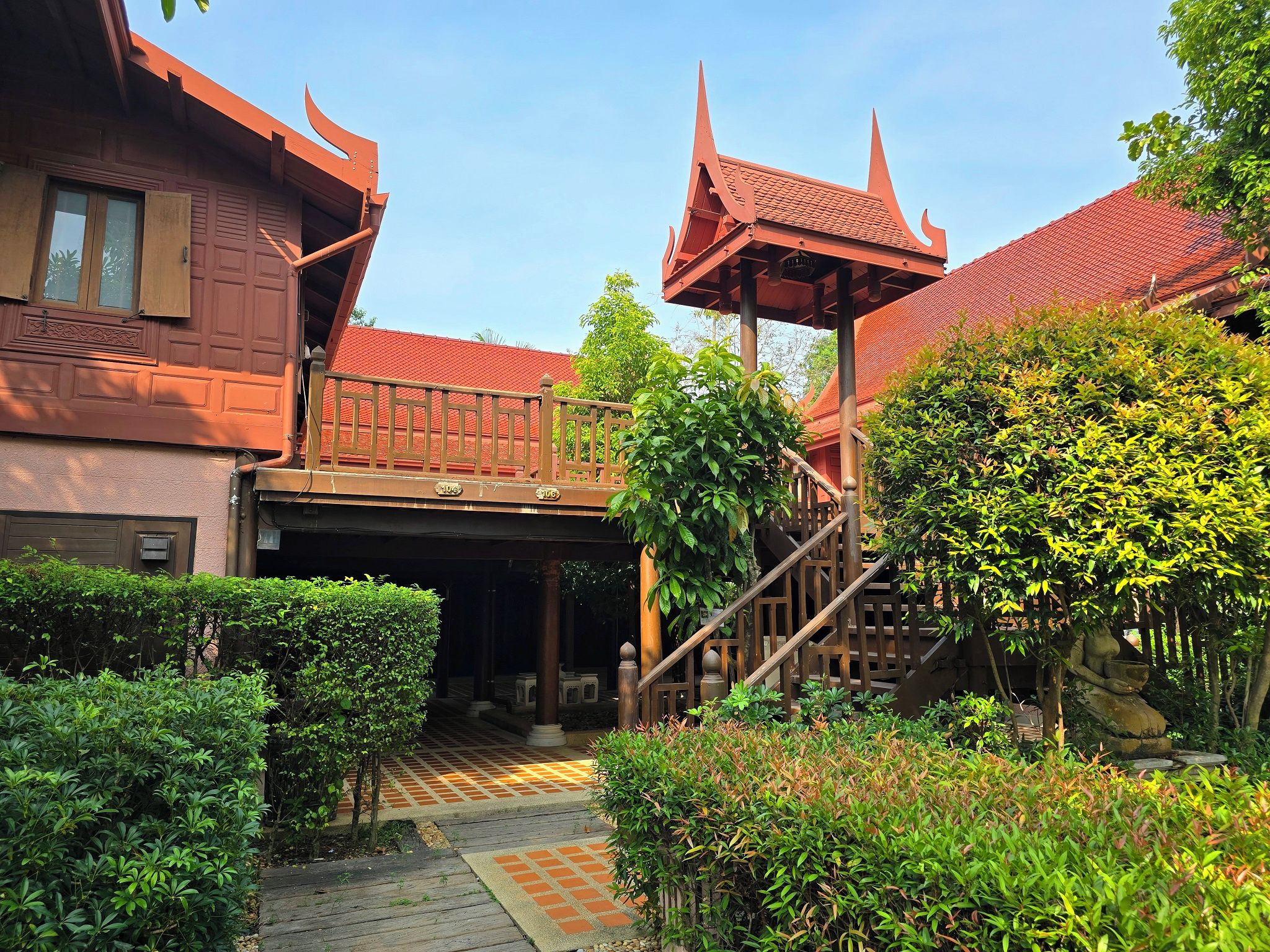 A traditional building with a red roof and a covered walkway.