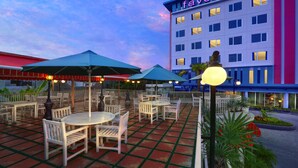 A hotel with outdoor seating and a well-lit entrance. - favehotel Sudirman Bojonegoro (Bojonegoro)