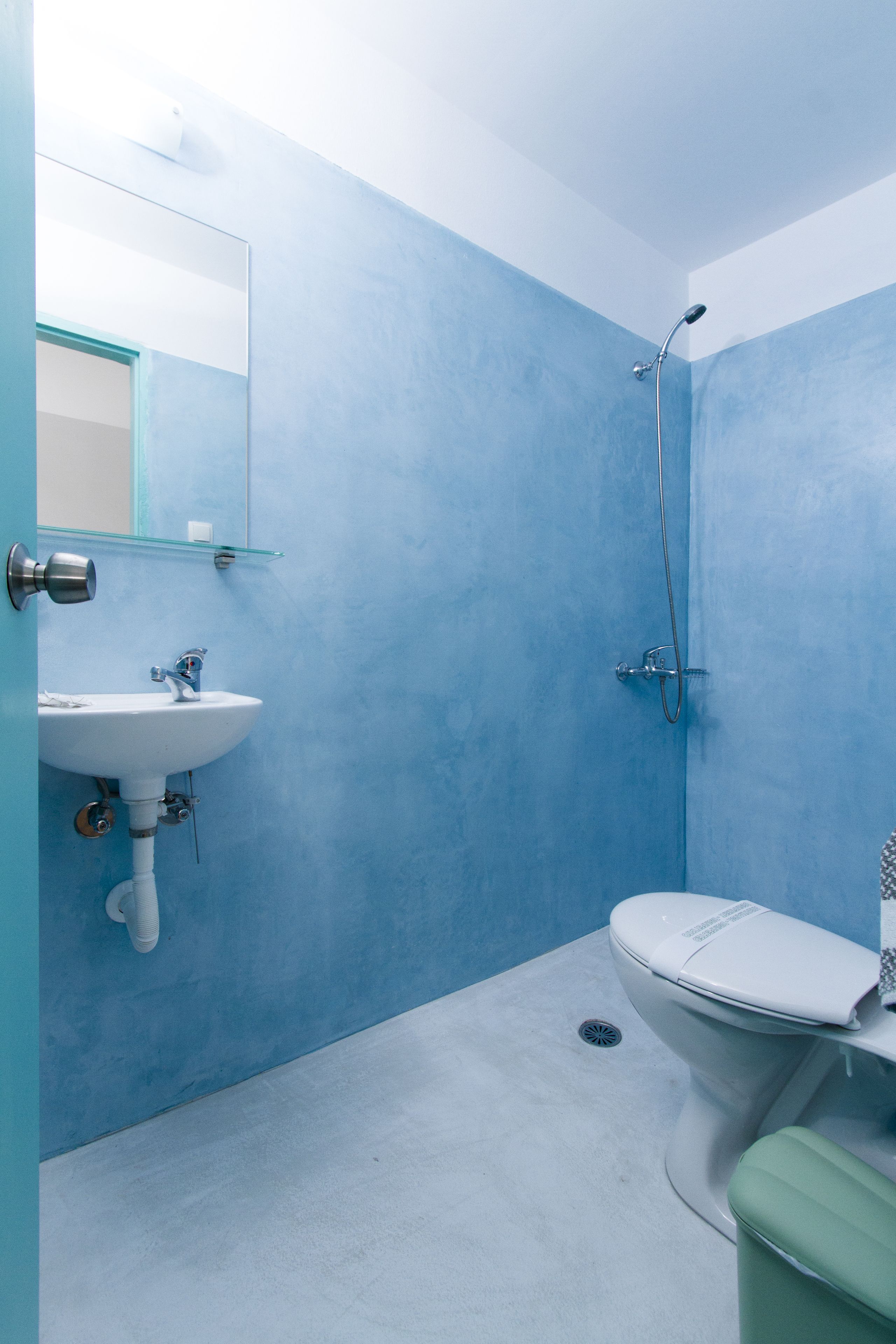 A bathroom with a sink, toilet, and shower.