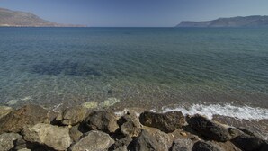 A rocky shoreline with clear water and distant mountains. - Kissamia - Self Check In Only - Next to Night Clubs (Kissamos)