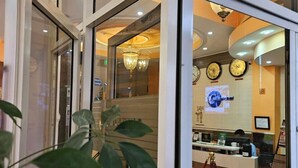 A hotel reception area with a counter, clocks, and a chandelier. - C fun Addis Hotel (Addis Ababa)