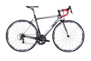 A stationary bicycle with a black frame, red and black handlebars, and a chain drive system. - Ramada Encore Wuhan (Wuhan)