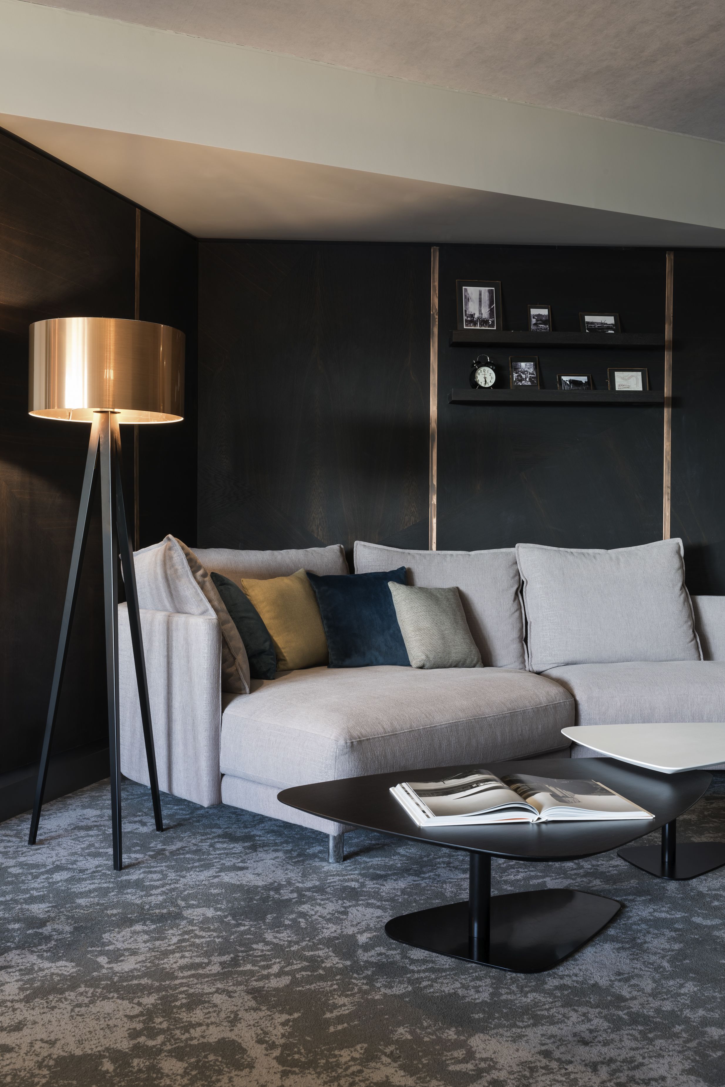 A modern living room with a sofa, a coffee table, and a floor lamp.