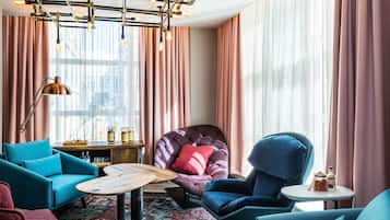 A modern living room with a sofa, armchair, and a coffee table.