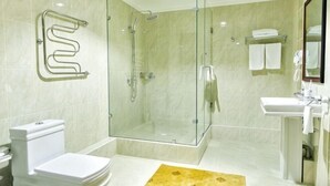 A modern bathroom with a glass-enclosed shower, a toilet, and a sink with a mirror. - Shymkent Grand Hotel (Shymkent)