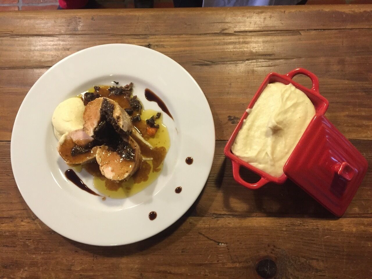 A plate of food with a red container beside it.