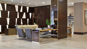A modern reception area with a reception desk, seating, and a decorative wall with geometric patterns.