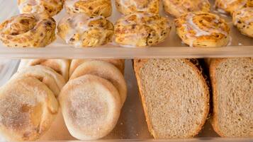 A bakery display case with various baked goods including pastries and bread.