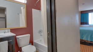 A bathroom with a toilet, sink, and bathtub. - Americas Best Value Inn Hayward (Hayward)