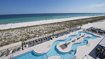 Alberca al aire libre, sombrillas en la alberca y camastros