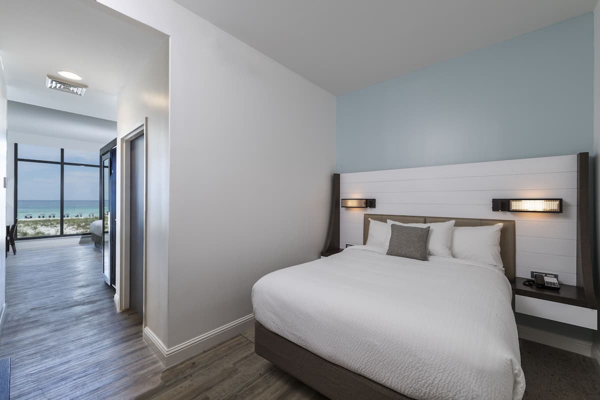 Premium bedding, desk, laptop workspace, blackout drapes