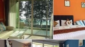 Una habitación de hotel con cama, ventana y vista a árboles.